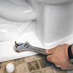 Attaching the toilet to the floor